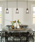Modern Farmhouse Pendant Light For Kitchen Island In Bronze Finish With Seeded Glass Shade in dining room setting