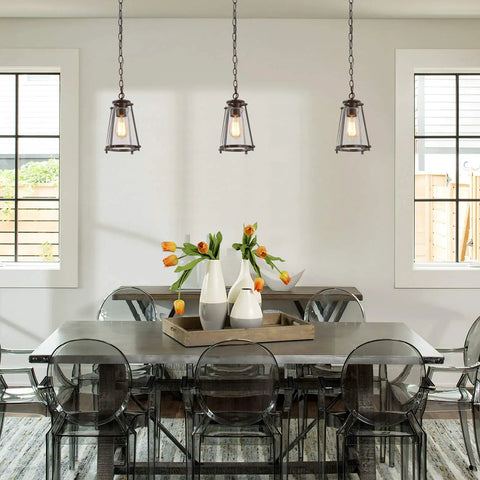 Modern Farmhouse Pendant Light For Kitchen Island In Bronze Finish With Seeded Glass Shade in dining room setting