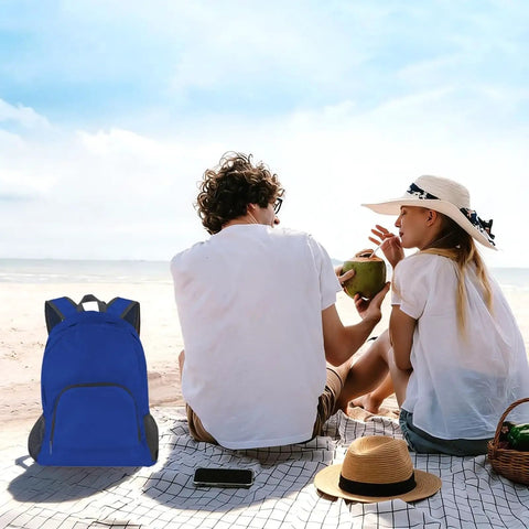 Couple on beach with Two-Pack Lightweight Foldable Backpack Set Water-Resistant Packable 20L Travel Hiking Bags Navy Blue and Royal Blue