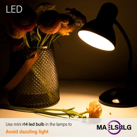 Tiny Reflector LED Bulbs For Curio Cabinet Lighting 40W Equivalent 2700K illuminating a desk lamp beside flowers at night.