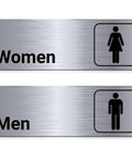 Two Pack Aluminum Restroom Signs For Men And Women Self Adhesive Metal Bathroom Door Wall Signage For Offices Restaurants Public Places 9 By 3 Inches Silvery Finish Easy Mount showing women and men graphics.