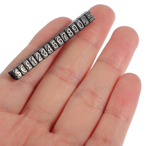 12 Set Jewelry Price Display Cubes With Black Numeric Blocks held on fingers