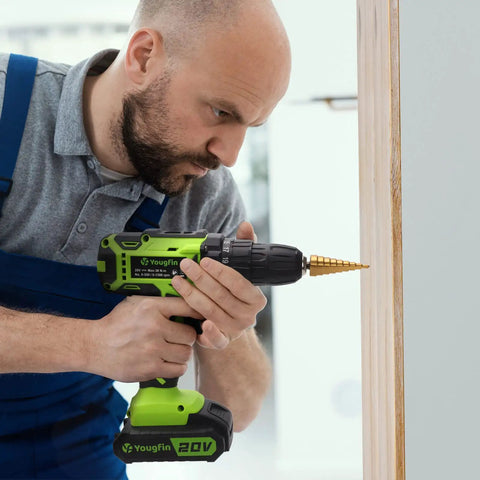 Person using Cordless Drill Set 20V With Battery And Charger Carrying Case 25 Plus 1 Torque Two Speed on wooden surface