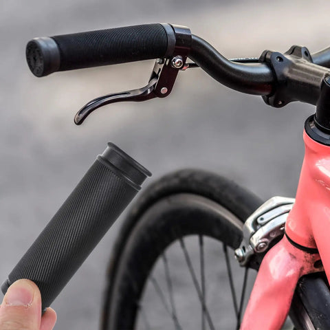 Person holding 4 Pack Bike Handlebar Grips Replacement Grippy Rubber Anti Slip for Mountain Bikes next to installed grip on bike