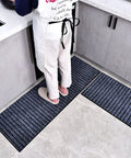 Solid Coffee Tamping Station With A Slick Integrated Espresso Knock Box And Grippy Portafilter Holder Tailored For 58Mm Barista Mats on kitchen floor.