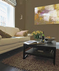 Living room with brown walls painted in Interior Paint And Primer In One Satin Finish 1 Gallon, artwork and sofa visible.