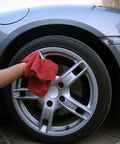 Person using 150 Pack Cotton Shop Towels Rags 14x12 Inches Absorbent, Reusable Cleaning Rags for polishing a car wheel