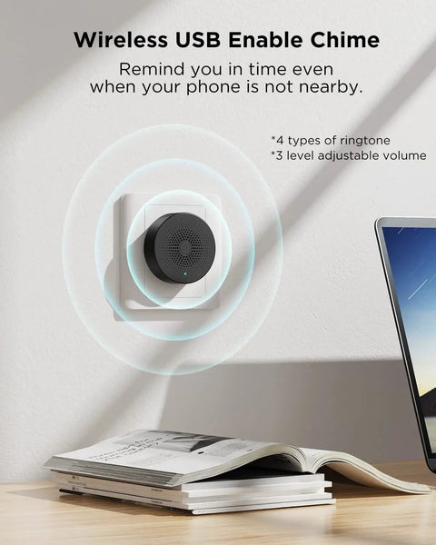 Wireless USB chime on wall next to laptop and book; features adjustable volume and multiple ringtones.