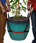 PotLifter plant mover straps lifting a large teal ceramic plant pot; two people hold straps