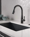 Matte Black Air Switch Kit For Disposal Easy Mount Button For Garbage Disposal Under Sink Or Countertop Plug In Switch With Second Outlet For An Extra Device Indoor Use next to black faucet and sink in modern kitchen setting