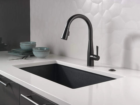 Matte Black Air Switch Kit For Disposal Easy Mount Button For Garbage Disposal Under Sink Or Countertop Plug In Switch With Second Outlet For An Extra Device Indoor Use next to black faucet and sink in modern kitchen setting