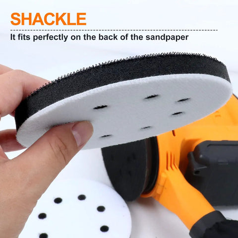 Close-up of 5 Inch 8 Holes Interface Pad for Orbital Sanders with Hook and Loop backing, held by hand, in front of tool.
