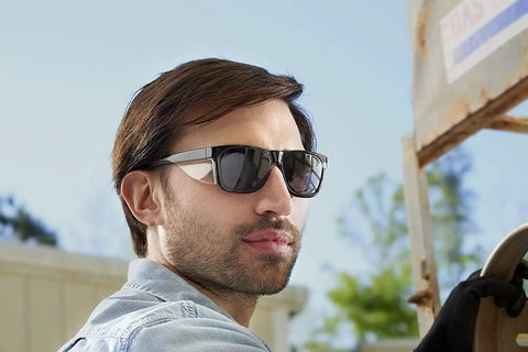 Man wearing Maverick Safety Glasses With Integrated Side Shields 3 Pack Smoke Anti Fog Lenses for eye protection outdoors.