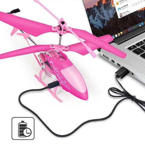 Pink RC Helicopter For Kids And Beginners 2.4GHz 3.5 Channel Indoor Flight Toy being charged via USB from a laptop