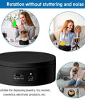 6 Piece Black Turner Cup Rotating Display Stand With USB Power Cable And Silent Motor Battery Backup For Kitchen Tumbler Organization on a countertop.