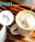 Powerful Rechargeable Milk Frother Wand With Stand in pink whisking coffee foam