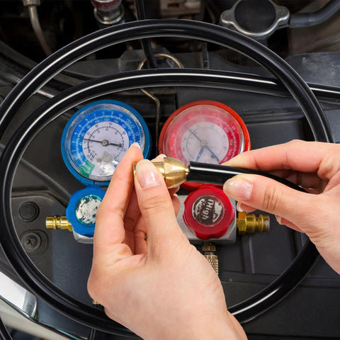 ZAVOOS silicone vacuum hose kit; hand-fitting brass adapter to black hose with blue/red vehicle gauges in background.
