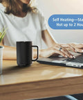 Premium Self Heating Rechargeable Coffee Mug With Precise Temperature Control And A Leak Proof Lid Keeps Your Favorite Brew Toasty on a desk.