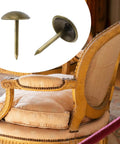 Antique Brass Upholstery Tacks with 3/8 Inch Round Head Dome, used on a vintage upholstered chair with plush cushion.
