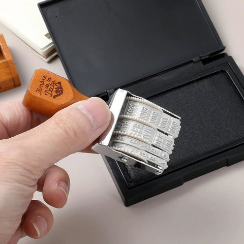 Top Shelf Adjustable Roller Date Stamp Nail Those Day Month Year Marks Zero Hassle Library Organizer And Craft Essential For Scrapbooking Journaling Office Work Dead Simple And Super Reliable held in hand, featuring a wood grip and date rollers.