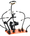 Magnetic Helping Hands Soldering Station with four arms, vise, LED magnifying lamp, and four PCB holders on a workbench.