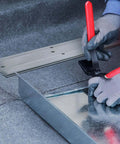 Worker using 18 Inch Folding Metal Bending Tool For Sheet Metal And HVAC Ductwork on sheet metal, showing red handle and bending process.