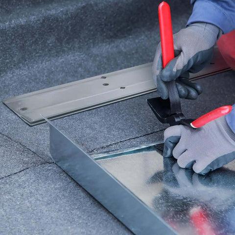 Worker using 18 Inch Folding Metal Bending Tool For Sheet Metal And HVAC Ductwork on sheet metal, showing red handle and bending process.