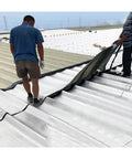 Two men applying Heavy Duty Self Adhesive Bitumen Roof Repair Tape Waterproof Underlayment Roll on a metal roof.