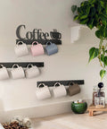 Coffee Mug Wall Rack With 12 Heavy Duty Hooks And Metal Sign For Coffee Bar Kitchen And Office Space Saving Wall Mounted Mug Organizer With Easy Access And Rustic Modern Style featuring mugs on three black racks