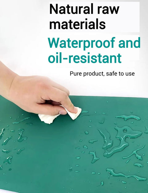 Close-up of green rubber ESD soldering mat being wiped; anti-static, heat-resistant desk mat for electronics repair.