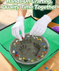All In One 10 Inch Stepping Stone Kit With Cement Mix Concrete Molds Mosaic Tiles Carving Tools Letter And Number Stamps Gloves And Mat in use, hands placing tiles