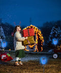 Child with festive gifts in snow with Blue Solar Torch Lights With Flickering Flames, 12 Pack Outdoor LED Tiki Torches For Yard And Garden