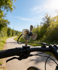 Compact 5W Wind Turbine Portable With LED Light for On The Go Power attached to bicycle handlebar on a sunny path