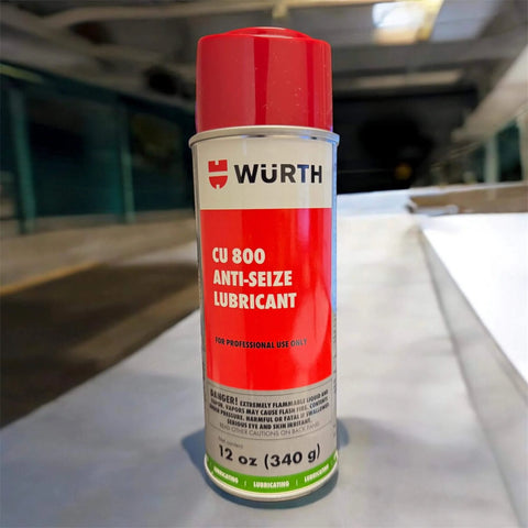 Wurth CU 800 Copper Anti Seize Lubricant, 12 Oz Heavy Duty Pro Grade Aerosol can on a table in an industrial setting.