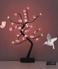 Cherry Blossom Tree Lamp For Living Room Decor And Cozy Night Light, DIY Artificial Tree Light For Home Weddings Christmas And More, USB Or Battery Powered Ambience, pink LED lights glowing on a desk.