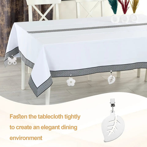 Stainless Steel Tablecloth Weights With Clips, Star Shaped Pendant 4 Pack on white tablecloth, outdoor dining decor, silver.