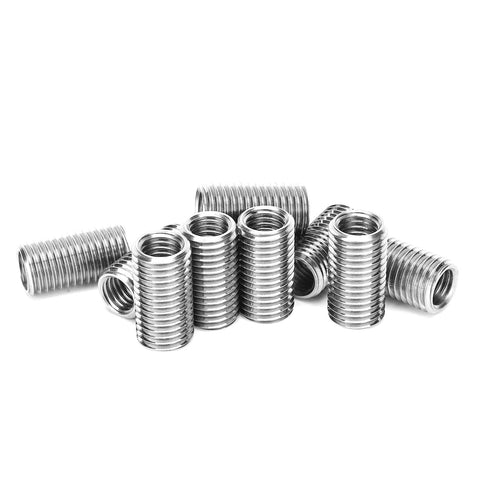 Front view of ten stainless steel thread repair sleeves with external threads for restoring damaged metal threads.