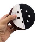 Five Pack 5 Inch Soft Density Interface Pads With Eight Hole Design, Hook And Loop Backing For Easy Swapping held in hand