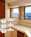 Super Secure 4 Pack White Marine Boat Ball Catch Roller Latch Spring Back Plates For Cabinet Doors And Cupboards, shown in a boat kitchen.