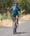 Cyclist riding mountain bike on a road, demonstrating balance with 26 inch heavy duty bike inner tubes 26 by 1.75 to 2.25 inch.