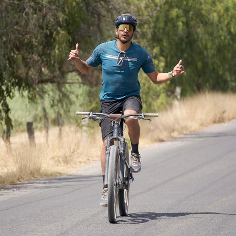 Cyclist riding mountain bike on a road, demonstrating balance with 26 inch heavy duty bike inner tubes 26 by 1.75 to 2.25 inch.