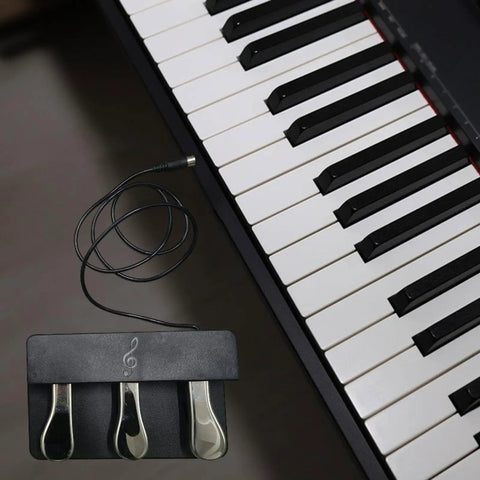 Three-Foot Pedal Unit For Digital Pianos And Keyboards With Universal 5-Pin Round Interface next to piano keys, metal pedals visible