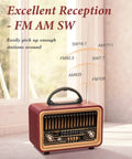 Retro Bluetooth Speaker With Deep Bass And Stereo Sound Portable AM FM Radio displayed on a table with antenna extended.