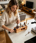 A woman using the Top Shelf 58mm Espresso Tamping Station Natural Wood Multifunctional Dosing Box Tool Organizer on a kitchen counter.