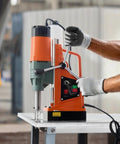 Rock Solid 1550W Magnetic Drill Press With 2922 Lbs Holding Power in use, adjusting speed on metal surface.