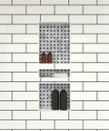Triple Niche Recessed Shower Shelf Black With Three Inner Shelves Built To Handle All Your Shower Stuff Fits 16 Inch Wide By 40 Inch High By 4 Inch Deep Tile Ready All In One Bathroom Storage Solution installed in white tiled wall with toiletries.