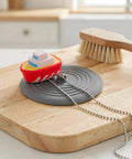 TEHAUX Silicone Bathtub Drain Stopper 6'', Hair Catcher for Bathroom in playful boat design on wooden surface.