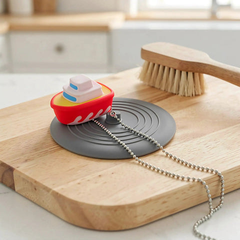 TEHAUX Silicone Bathtub Drain Stopper 6'', Hair Catcher for Bathroom in playful boat design on wooden surface.