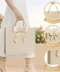 Medium Gift Bags With Handles Set Includes Ribbon Card And Two Tissue Papers For Weddings Birthdays Baby Showers Engagements And Mothers Day Champagne Beige Paper Gift Bags For Party Favors showing durable handle and bow design