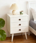 12 Pack Round Walnut Wood Drawer Handles 1.53 Inch Single Hole Cabinet Knobs with screws on white dresser beside bed.
